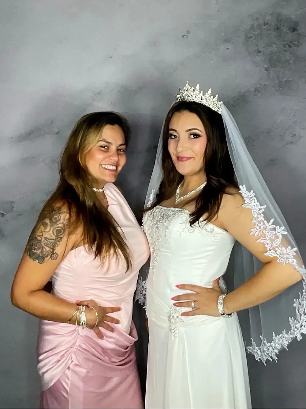 Bride and friend smiling in the photo booth